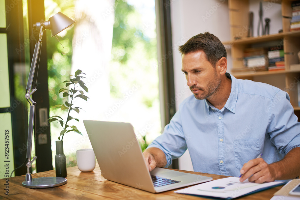 Man, reading and laptop with documents for remote work from home office with charts, stats or financial review. Person, computer and paperwork with info, insight and feedback for trading in apartment Man, reading and laptop with documents for remote work from home office with charts, stats or financial review. Person, computer and paperwork with info, insight and feedback for trading in apartment