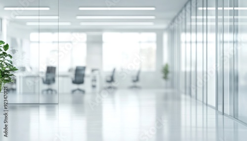 Modern office interior with glass walls and green plants during daylight