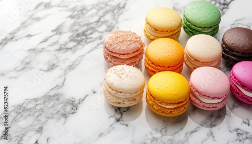Colorful macarons arranged on a marble countertop in various flavors and pastel colors