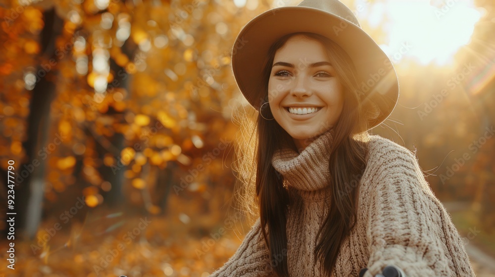 A young woman beams with happiness amid a forest of golden autumn leaves, radiating warmth as sunlight filters through the trees A young woman beams with happiness amid a forest of golden autumn leaves, radiating warmth as sunlight filters through the trees