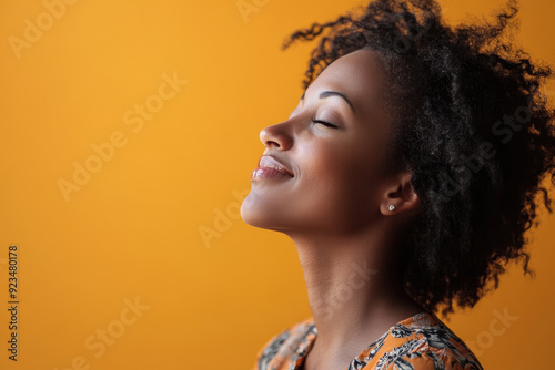 A close up of a black woman's face with her eyes closed