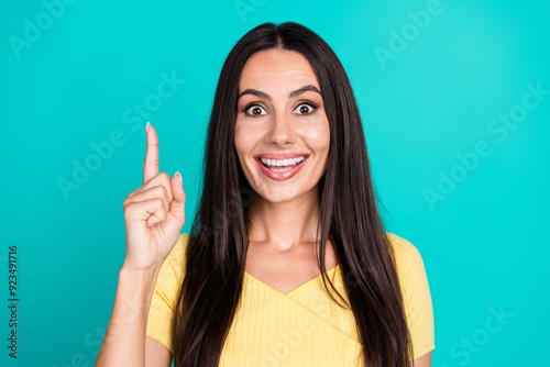 Portrait of pretty young woman point finger wear top isolated on turquoise color background