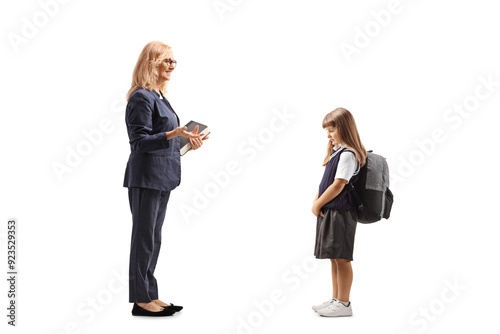 Fotografie Full length profile shot of a teacher talking to a sad little schoolgirl
