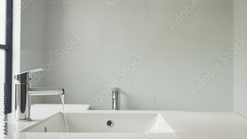 Modern White Bathroom Sink with Running Water in Minimalist Setting