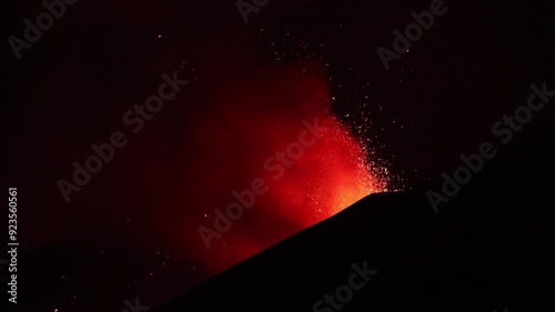 Etna Volcano eruption in the night with greatest lava explosion from top crater - Sicily photo