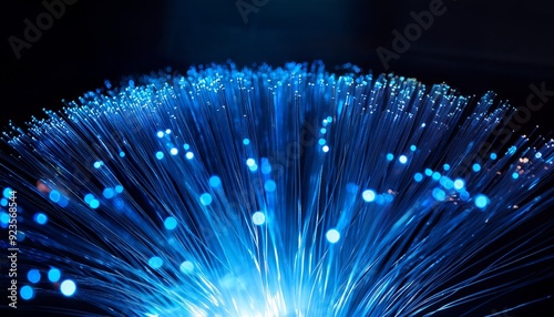 Blue Data Stream Fiber optic cables transmit data as a luminous current, illuminating the darkness with vibrant, electric blue bokeh.