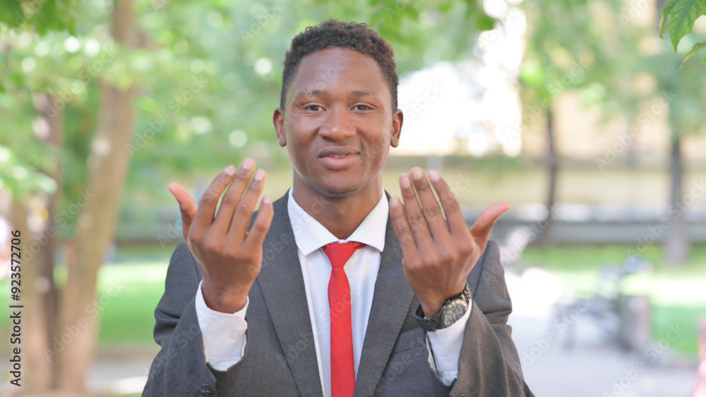 Inviting Gesture by African Businessman Outdoor