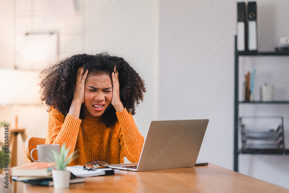 Stressed African American Woman at Desk with Laptop.