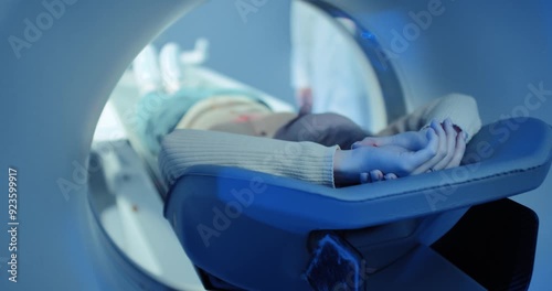 Female patient undergoes MRI or CT scan.