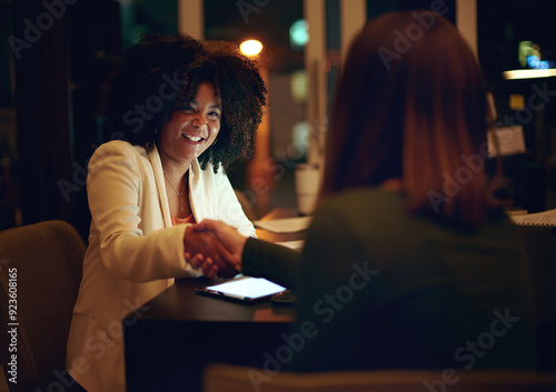 Business, women and shaking hands for partnership at night with b2b collaboration, agreement and financial deal. Professional people, tablet and handshake in office for congratulations and teamwork