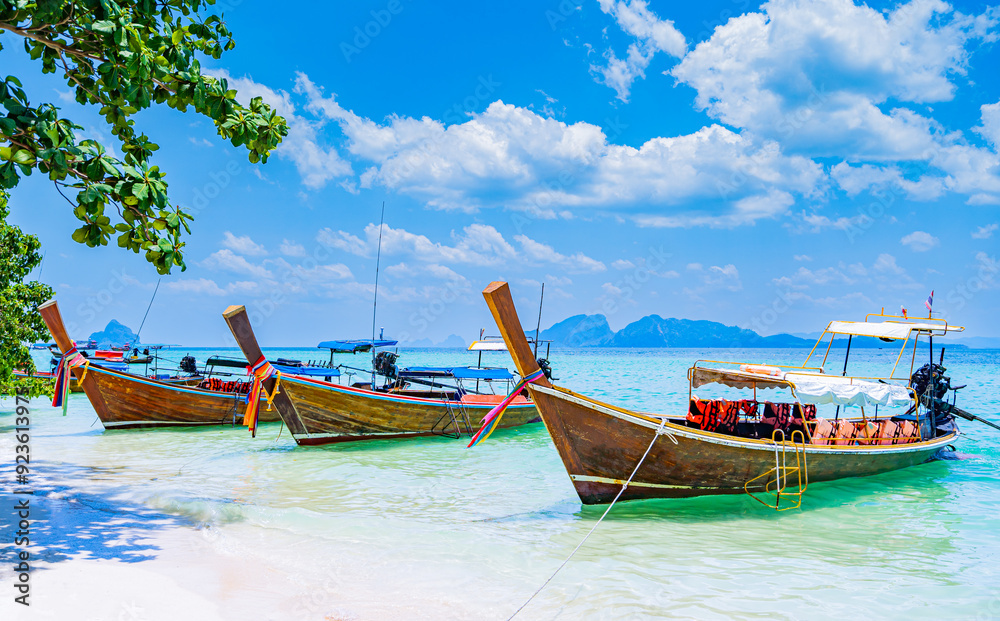 Sea, sandy beach with long tail boats on the beach of Kradan island or Koh Kradan, Trang Province, southern Thailand, Asia Sea, sandy beach with long tail boats on the beach of Kradan island or Koh Kradan, Trang Province, southern Thailand, Asia