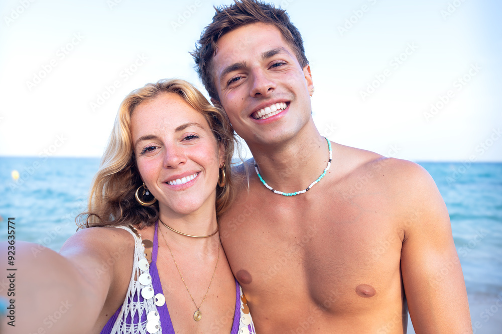 Two young friends on the beach looking at the camera Two young friends on the beach looking at the camera