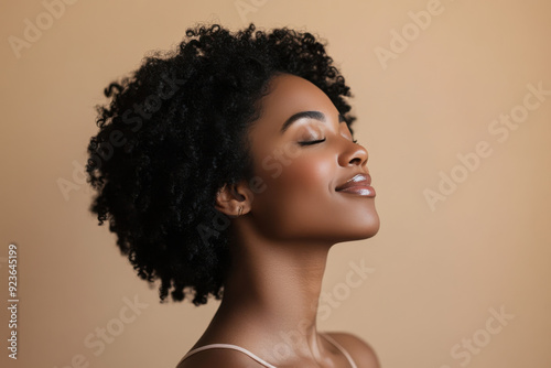 A close up of a black woman's face with her eyes closed