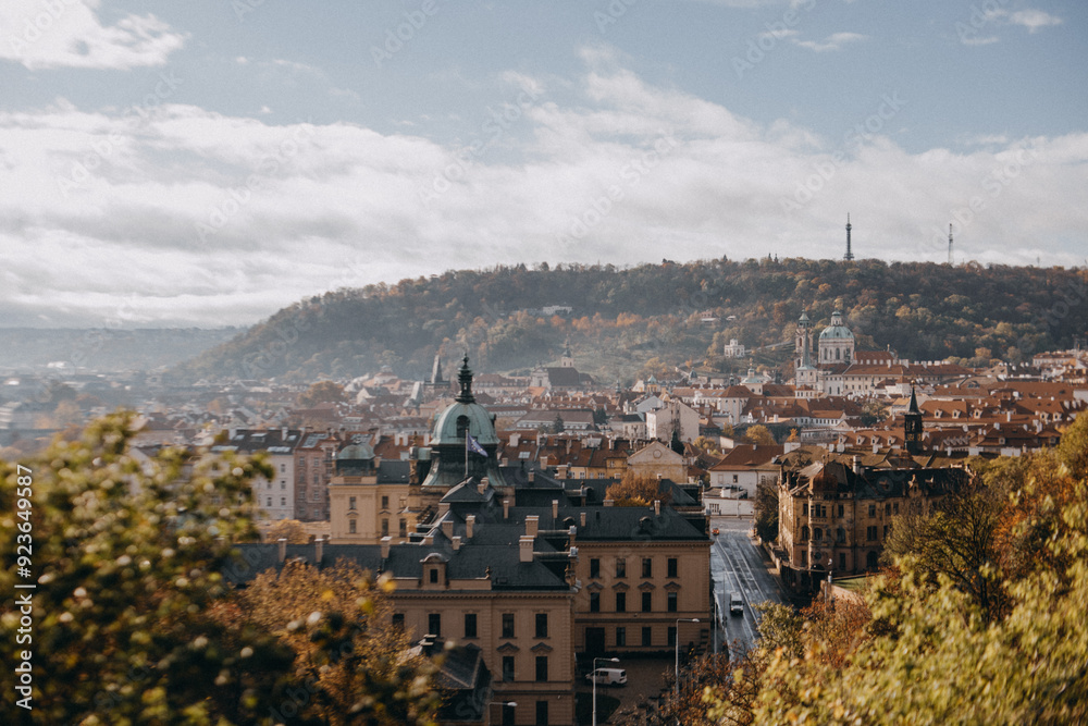 Fototapeta premium Panoramic view of a city with autumn foliage from the Letna Park during autumn in Prague