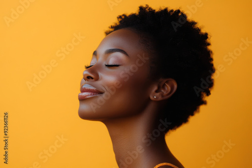 A close up of a black woman's face with her eyes closed