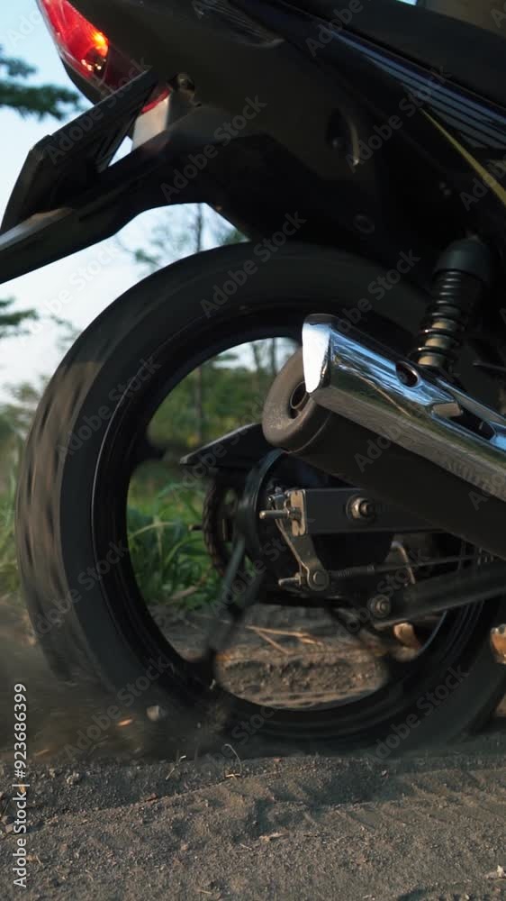 Slow motion rear wheel of a motorbike skidding on the sand. Footage of a motorcyclist getting stuck on a sandy road and trying to pull on the gas until sand flies from under the wheels. Slow motion rear wheel of a motorbike skidding on the sand. Footage of a motorcyclist getting stuck on a sandy road and trying to pull on the gas until sand flies from under the wheels.