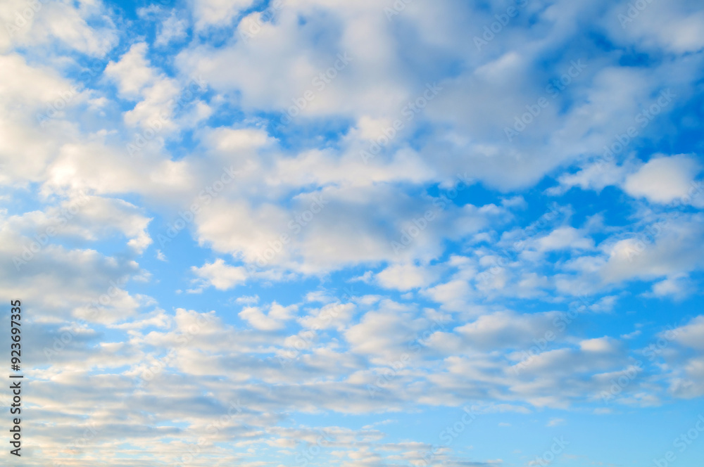 Blue sky background with white colorful clouds and soft sunlight Blue sky background with white colorful clouds and soft sunlight