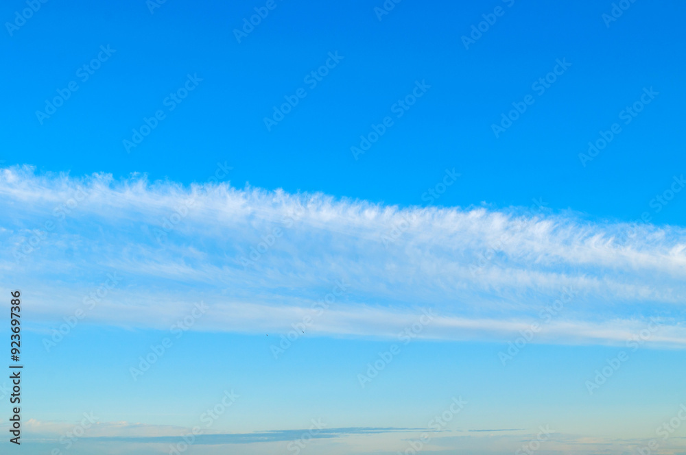 Blue sky background with white dramatic colorful clouds and sunlight Blue sky background with white dramatic colorful clouds and sunlight