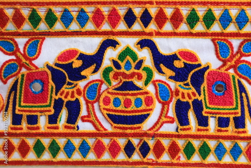 traditional fabric lace with kachchhi work for navratri outfits. Gujarati designer outfit for chaniya choli and interior decoration. Elephant and pot design on the fabric for cultural outfit in India  photo