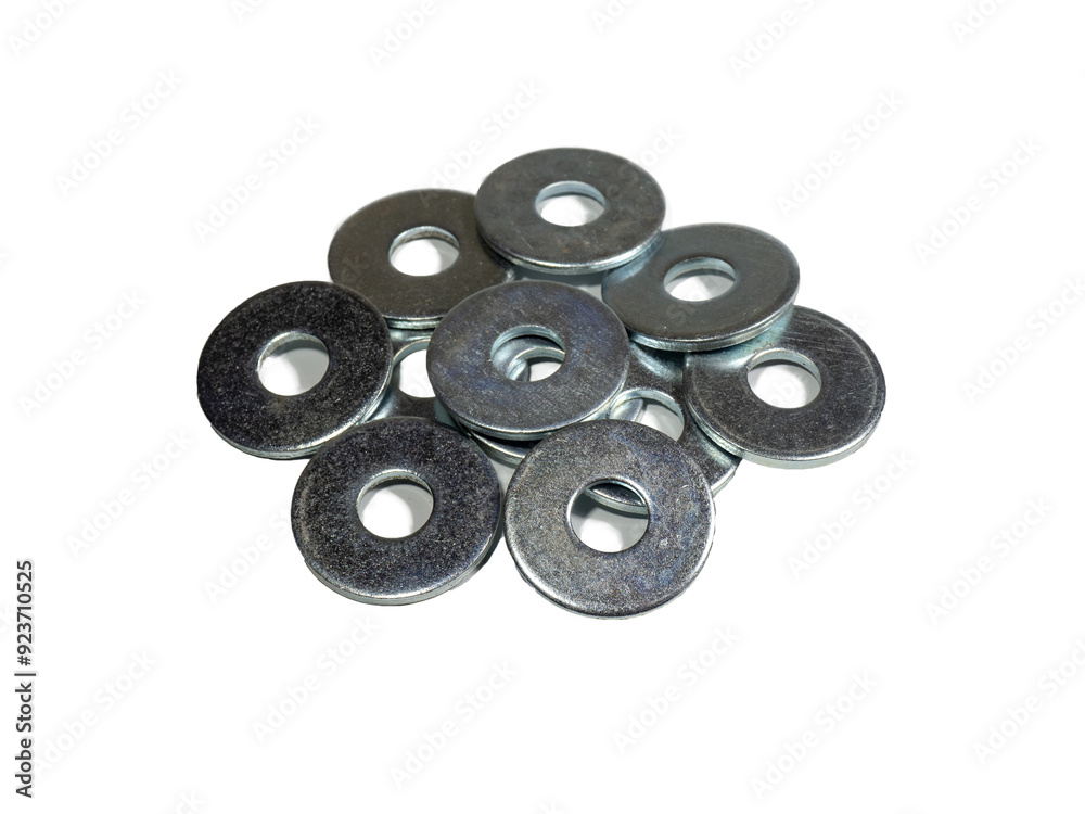 Flat metal penny washers. A scattering of metal washers for bolts and screws. Construction materials and accessories Flat metal penny washers. A scattering of metal washers for bolts and screws. Construction materials and accessories