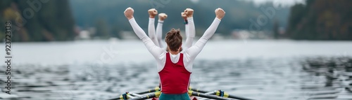 Rowing team celebrates victory with arms raised in the air