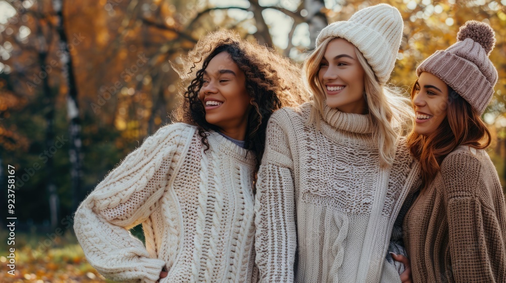 Fototapeta premium Warm Moments: Friends in Cozy Sweaters Taking a Stroll in the Park