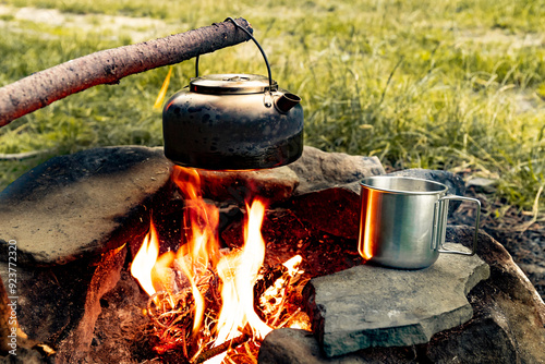 Coffee pot on a campfire during a hike in the mountains. photo