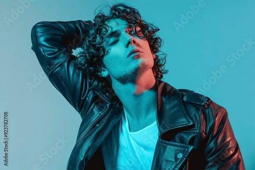 A Portrait of a stylish man with curly hair on a blue backer