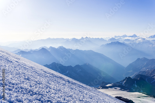 view from highland glacier to misty mountains in the rays of dawn photo