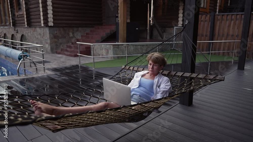 Wallpaper Mural Middle aged woman in a hammock with a laptop. Torontodigital.ca