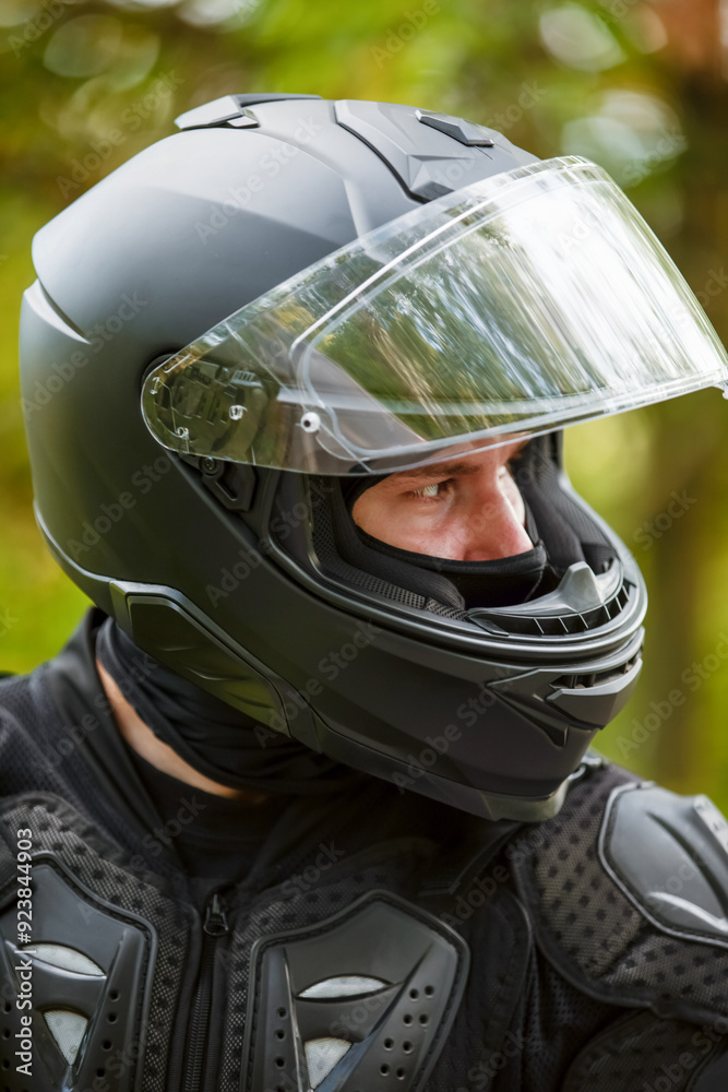 portrait of a motorcyclist in a black helmet portrait of a motorcyclist in a black helmet