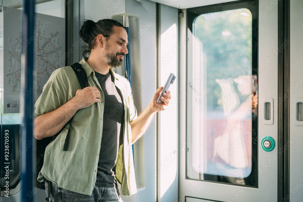 © Anna - A Caucasian man with a phone rides on the train, in the skytrain, in the subway. Urban transport. © Anna - A Caucasian man with a phone rides on the train, in the skytrain, in the subway. Urban transport.