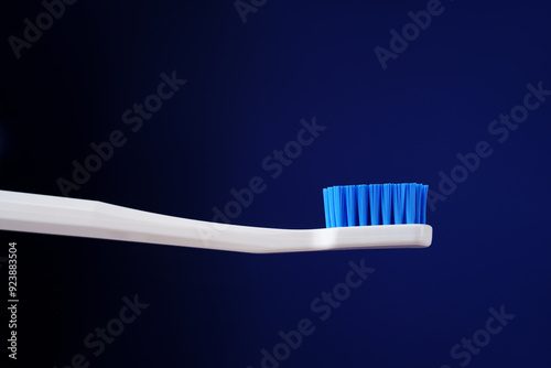 Dental king concept. Hygiene. Advertising banner. White toothbrush on a dark blue gradient background. photo