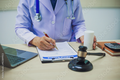 The hammer of justice is a law protecting doctors in diagnosing patients and leading to their death. Hospital insurance considers safety in judgment with lawyers, judges, courts, copy space.