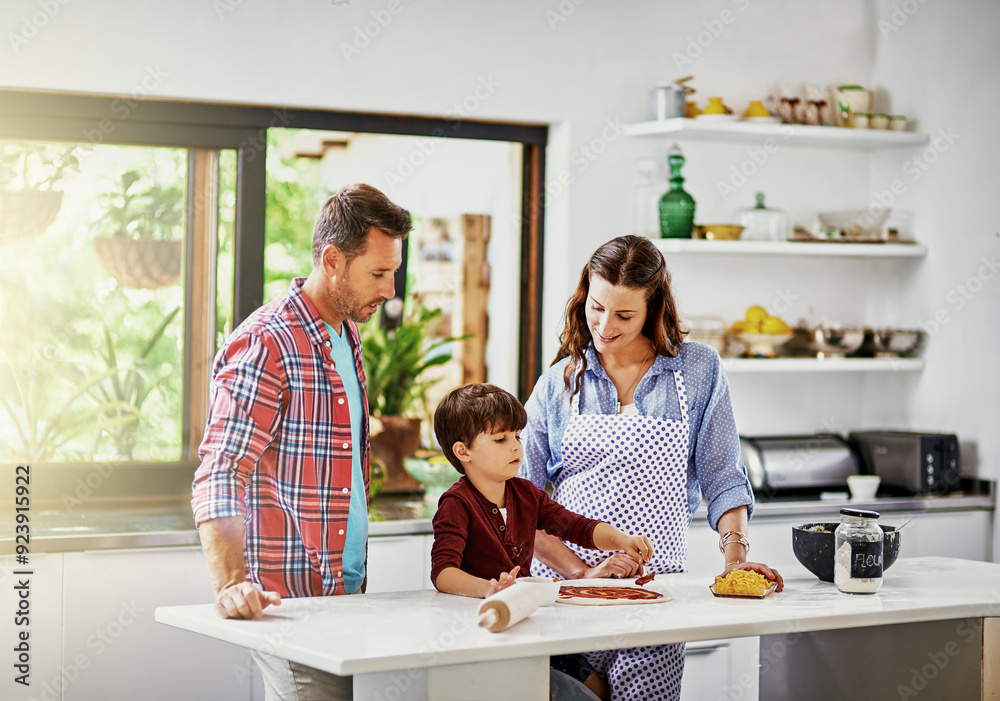 Obraz premium Parents, boy and happy with baking pizza in kitchen for playing, fun and child development or growth. Family, people and kid at home with teaching or learning for bonding, support and care with smile