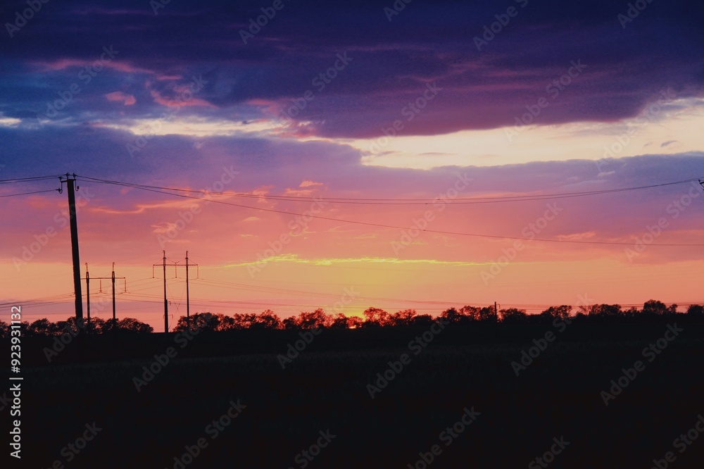 Lilac and pink sunset against the background of a field Lilac and pink sunset against the background of a field
