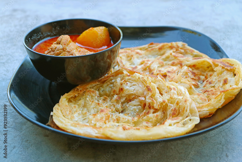 Tasty Spicy Indian Chicken Curry Served with Roti Flatbread Tasty Spicy Indian Chicken Curry Served with Roti Flatbread