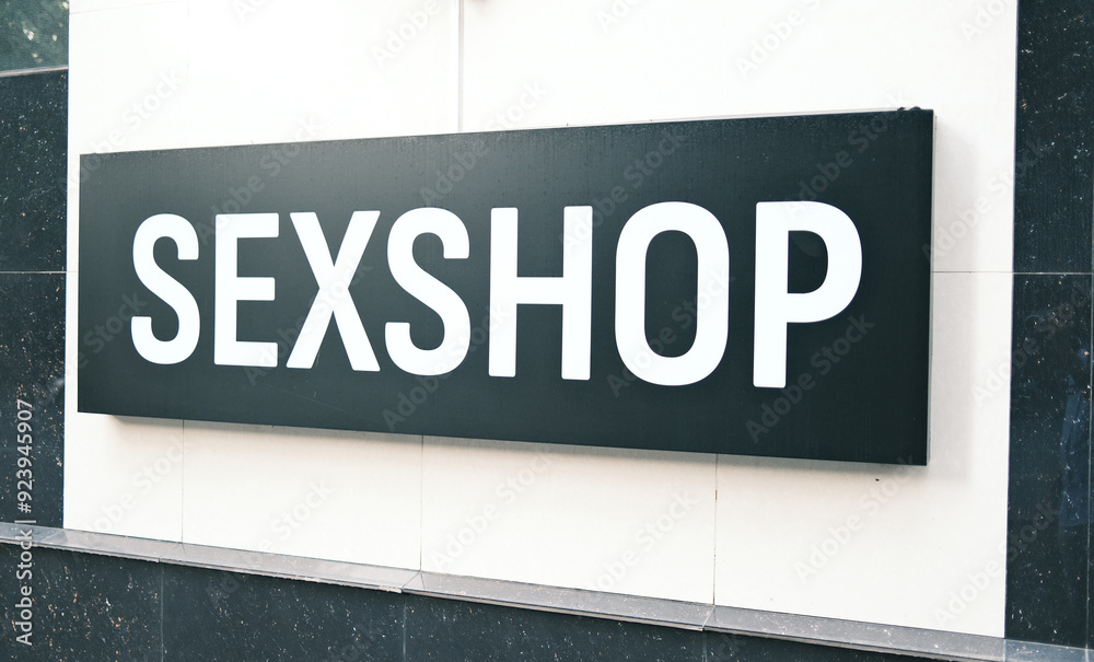 Adult Store Signage: Black and White 'SEXSHOP' Sign on Building Exterior Adult Store Signage: Black and White 'SEXSHOP' Sign on Building Exterior