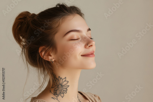 A close up of a woman's face with tattoos and her eyes closed