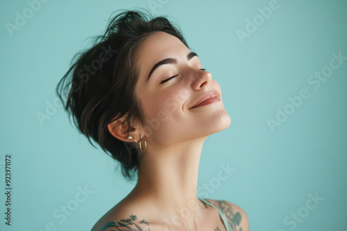 A close up of a woman's face with tattoos and her eyes closed