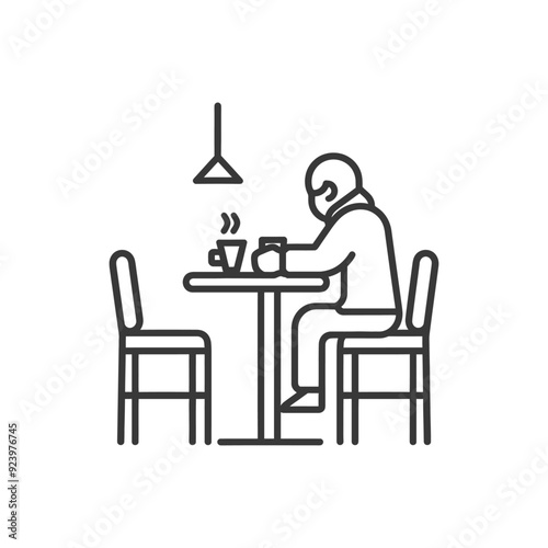 Person sitting alone at a table with a steaming cup of coffee