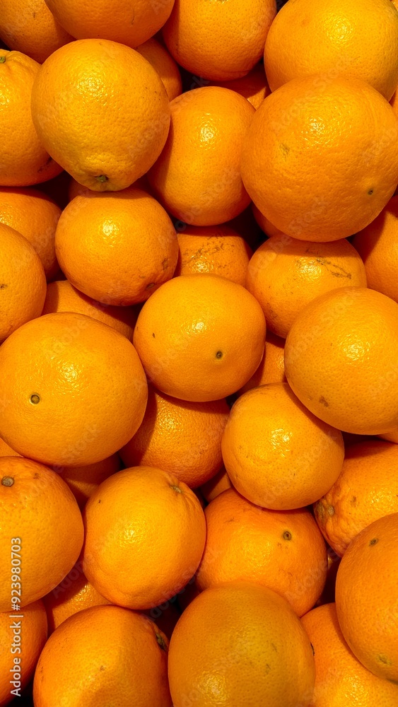 A close-up view of fresh oranges, showcasing their vibrant orange color and natural texture A close-up view of fresh oranges, showcasing their vibrant orange color and natural texture
