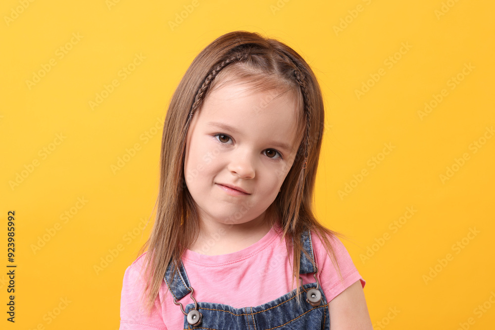 Portrait of cute little girl on orange background Portrait of cute little girl on orange background