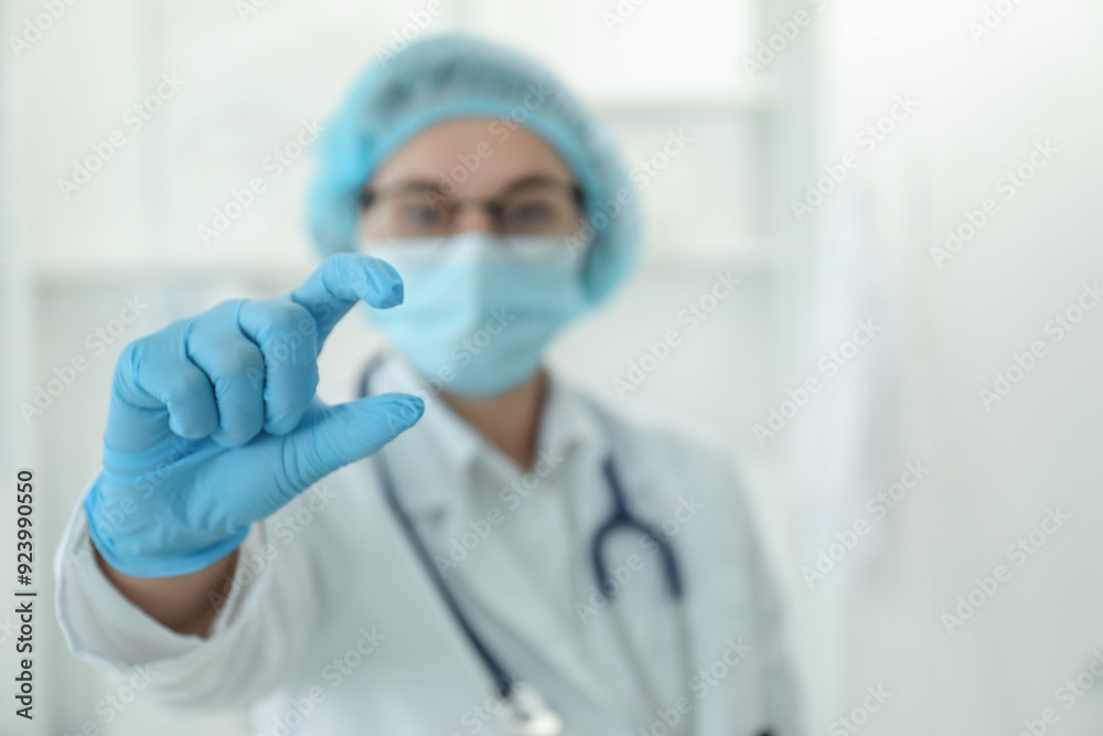 Doctor holding something in clinic, selective focus. Space for text Doctor holding something in clinic, selective focus. Space for text