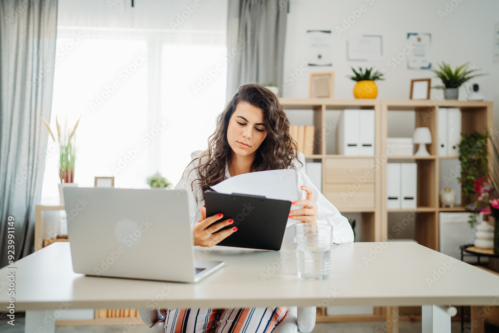 Young caucasian business woman working in office on laptop Young caucasian business woman working in office on laptop