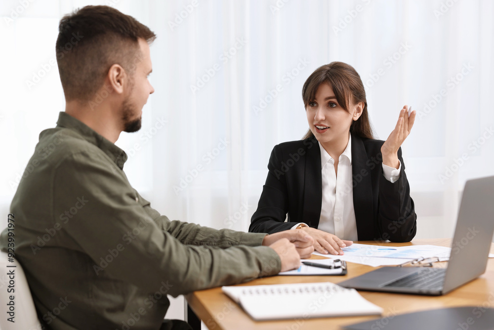 Consultant working with partner at table in office. Business meeting Consultant working with partner at table in office. Business meeting