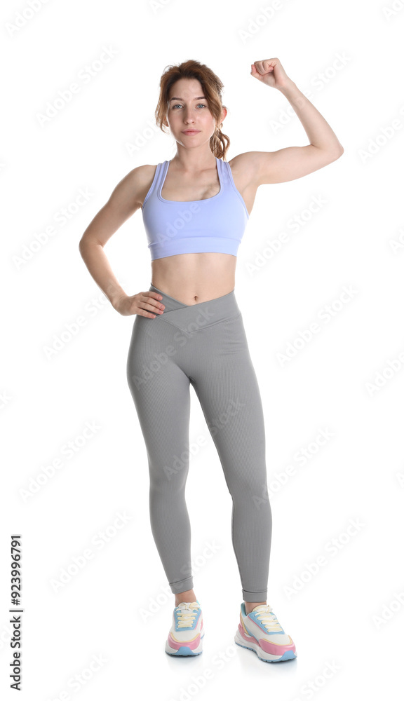 Woman with slim body showing muscles on white background Woman with slim body showing muscles on white background