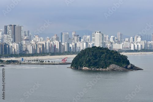 Landscape of Santos city with view to the Urubuquecaba Island, the breakwater, the beach and the city on background. Coast of the interior of Sao Paulo, SP, Brazil. photo