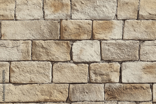 Rustic stone wall with rectangular beige bricks, creating a rugged seamless pattern. The texture evokes a sense of durability, strength, and timeless architecture.