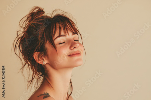 A close up of a woman's face with tattoos and her eyes closed